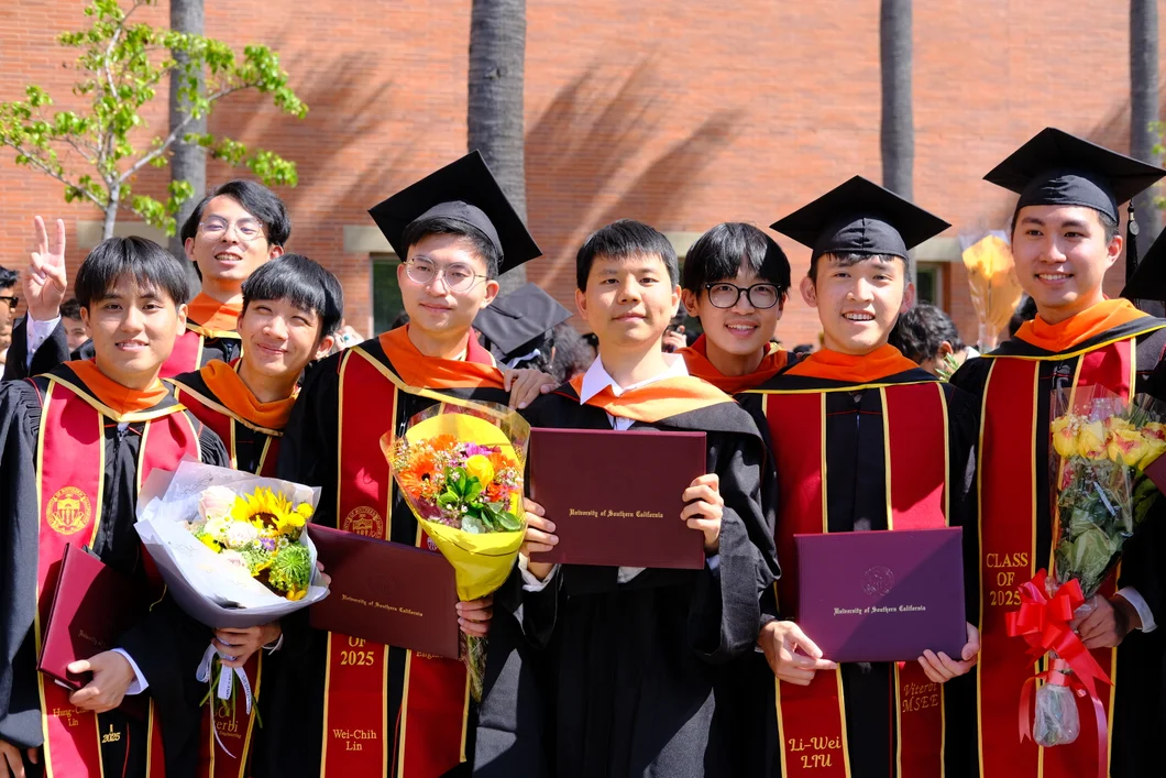 Frank (center) with USC EE Class of 2025 classmates at graduation